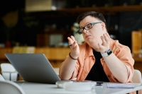 man with intellectual and/or developmental disabilities attending webinar on computer. 